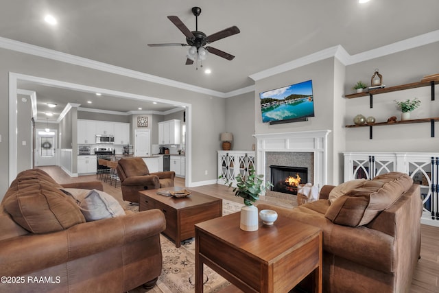 113 Spider Lily Ln, Lafayette, LA 70508 - living room with recessed lighting, light wood-style floors, ceiling fan, crown molding, and a fireplace