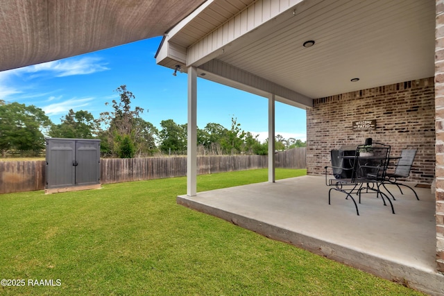 113 Spider Lily Ln, Lafayette, LA 70508 - exterior space featuring a fenced backyard, a storage unit, and an outbuilding