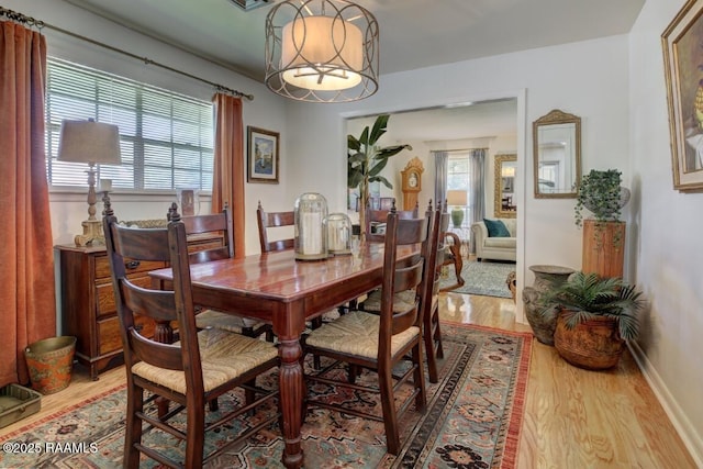 304 Broadmoor Blvd, Lafayette, LA 70503 - dining room with light wood finished floors, baseboards, and a notable chandelier