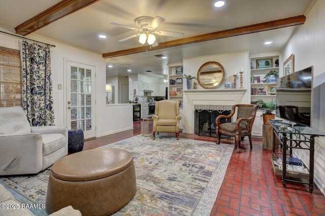 304 Broadmoor Blvd, Lafayette, LA 70503 - living room with ceiling fan, ornamental molding, brick floor, and a fireplace
