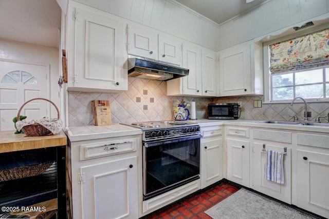 304 Broadmoor Blvd, Lafayette, LA 70503 - kitchen with under cabinet range hood, electric stove, a sink, brick floor, and black microwave