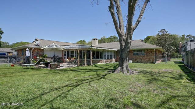304 Broadmoor Blvd, Lafayette, LA 70503 - back of house with brick siding, a lawn, a patio, and a fenced backyard