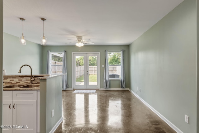 1612 Dehart Dr Unit A, New Iberia, LA 70560 - interior space featuring a ceiling fan, a sink, french doors, finished concrete flooring, and baseboards