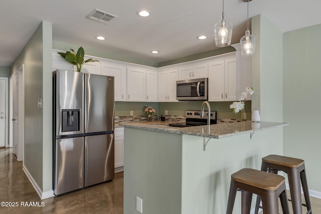 1612 Dehart Dr Unit A, New Iberia, LA 70560 - kitchen featuring light stone counters, stainless steel appliances, a peninsula, finished concrete flooring, and white cabinetry