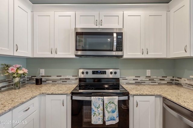 1612 Dehart Dr Unit A, New Iberia, LA 70560 - kitchen featuring white cabinets, light stone countertops, decorative backsplash, and stainless steel appliances