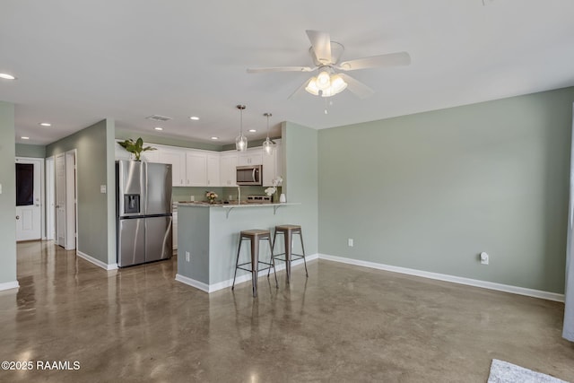 1612 Dehart Dr Unit A, New Iberia, LA 70560 - kitchen with stainless steel appliances, baseboards, a kitchen bar, finished concrete flooring, and white cabinetry