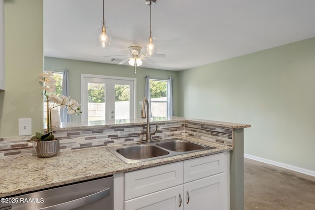 1612 Dehart Dr Unit A, New Iberia, LA 70560 - kitchen with stainless steel dishwasher, a sink, ceiling fan, french doors, and white cabinets
