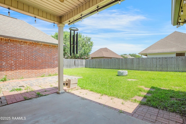 view of yard featuring a patio and a fenced backyard