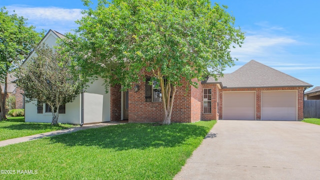view of front of house featuring brick siding, an attached garage, driveway, and a front yard