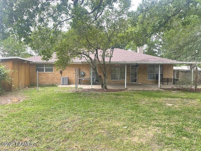 210 Essex St, Lafayette, LA 70506 - rear view of house featuring a chimney, fence, a yard, a patio area, and brick siding