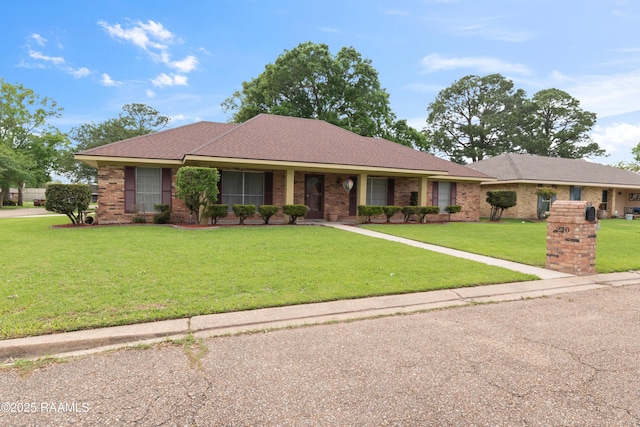 220 N Philo Dr, Lafayette, LA 70506 - ranch-style home featuring a front lawn and brick siding