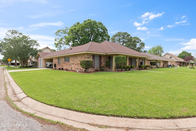 220 N Philo Dr, Lafayette, LA 70506 - single story home with brick siding, a front lawn, driveway, and an attached garage