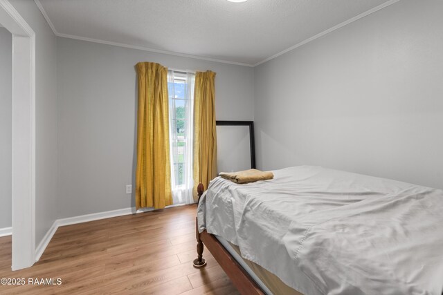 220 N Philo Dr, Lafayette, LA 70506 - bedroom with wood finished floors, baseboards, and ornamental molding