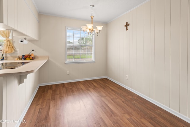 220 N Philo Dr, Lafayette, LA 70506 - unfurnished dining area with ornamental molding, baseboards, a notable chandelier, and wood finished floors