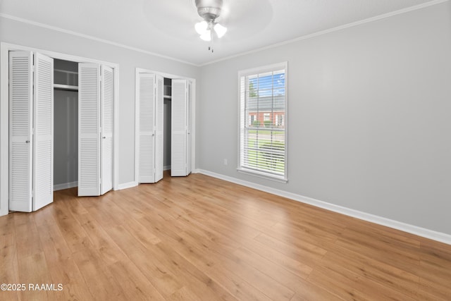 220 N Philo Dr, Lafayette, LA 70506 - unfurnished bedroom featuring light wood-type flooring, baseboards, ceiling fan, multiple closets, and ornamental molding
