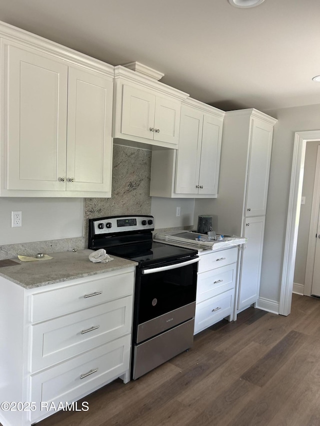 347 Marie St, Sunset, LA 70584 - kitchen featuring white cabinets, stainless steel electric stove, dark wood-style floors, and light stone counters