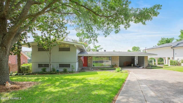 221 Beverly Dr, Lafayette, LA 70503 - split level home with driveway, an attached carport, and a front yard
