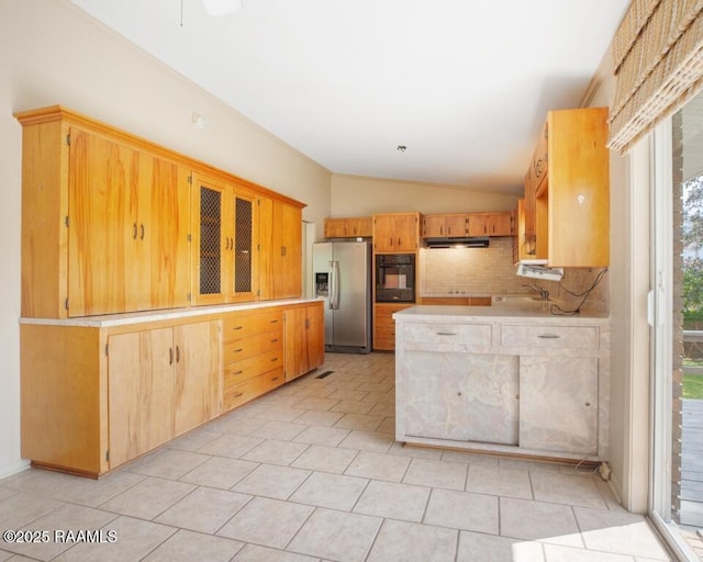 221 Beverly Dr, Lafayette, LA 70503 - kitchen featuring stainless steel fridge, vaulted ceiling, light countertops, under cabinet range hood, and black oven
