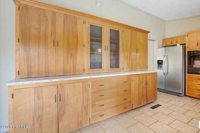 221 Beverly Dr, Lafayette, LA 70503 - kitchen featuring oven, stainless steel fridge with ice dispenser, light countertops, ornamental molding, and glass insert cabinets