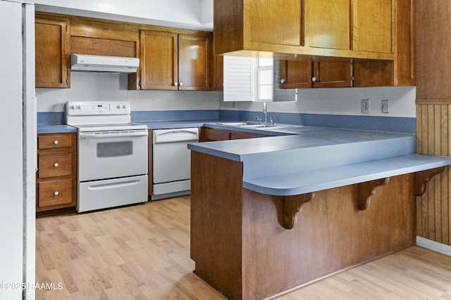 2318 Helen St, Abbeville, LA 70510 - kitchen with white appliances, a peninsula, a sink, and light wood-type flooring
