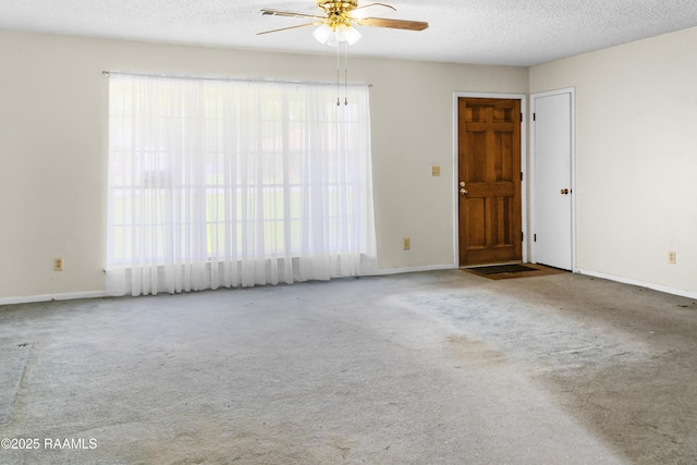 2318 Helen St, Abbeville, LA 70510 - empty room with carpet floors, a textured ceiling, ceiling fan, and baseboards