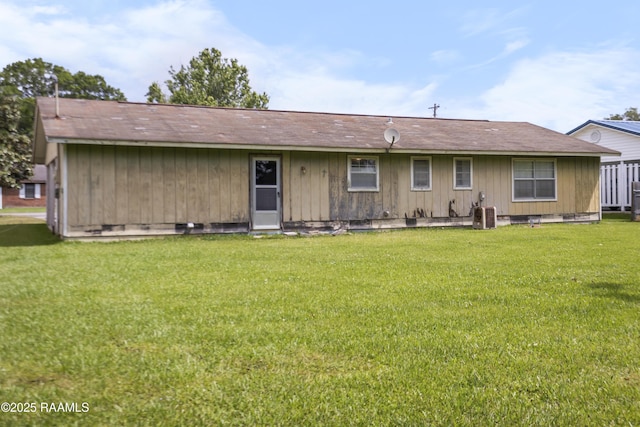 2318 Helen St, Abbeville, LA 70510 - back of house with a lawn and central AC