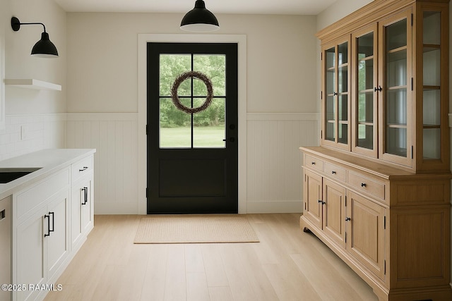 2318 Helen St, Abbeville, LA 70510 - doorway featuring light wood-style floors and a wainscoted wall