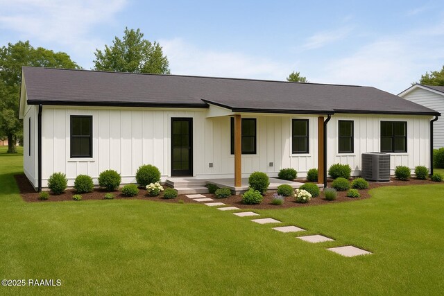 2318 Helen St, Abbeville, LA 70510 - view of front of home with board and batten siding, central AC, covered porch, and a front yard