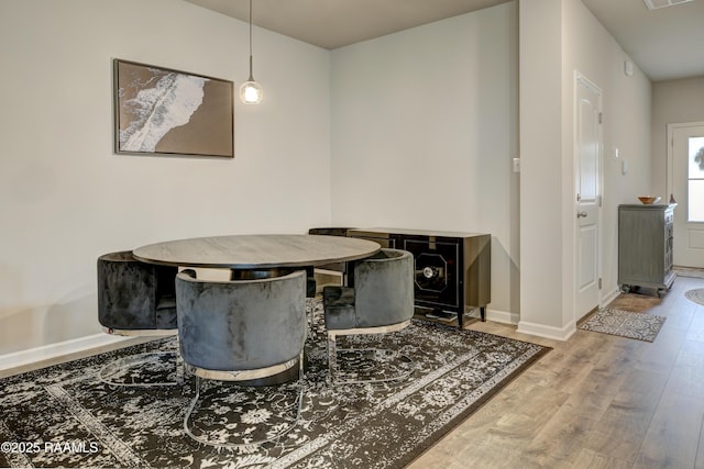 dining room featuring baseboards and wood finished floors