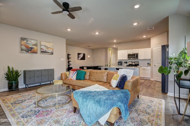 living area featuring wood finished floors, visible vents, recessed lighting, and ceiling fan