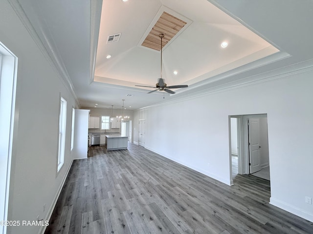 219 Berchman Oaks Dr, Lafayette, LA 70506 - unfurnished living room with a raised ceiling, recessed lighting, crown molding, baseboards, and wood finished floors