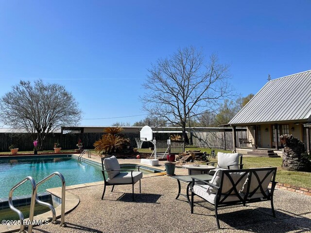 view of swimming pool featuring a fenced backyard, a fenced in pool, and a patio