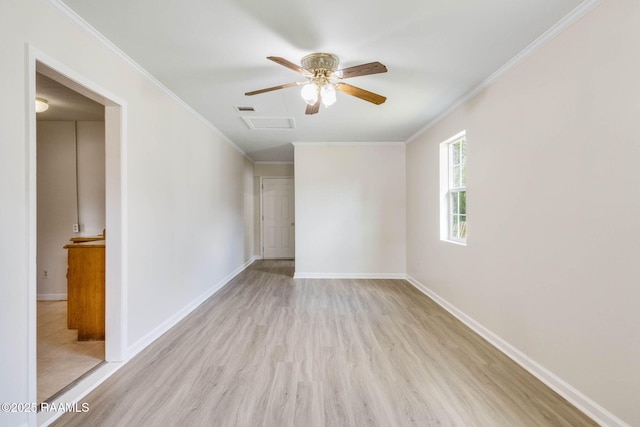spare room featuring crown molding, wood finished floors, attic access, ceiling fan, and visible vents