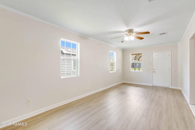 empty room with baseboards, light wood-style floors, ceiling fan, and crown molding