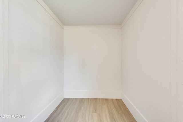 spare room featuring light wood-style floors and baseboards
