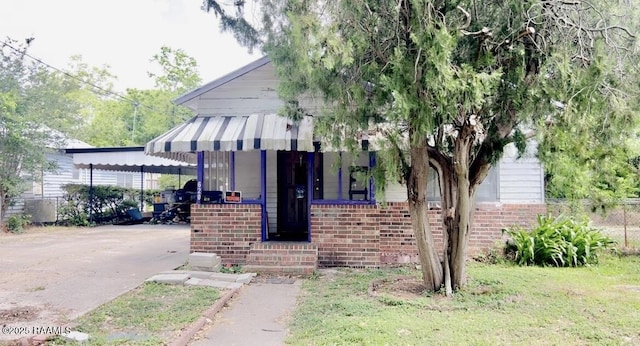 620 Boudreaux St, Franklin, LA 70538 - view of front of house featuring brick siding, concrete driveway, and a carport