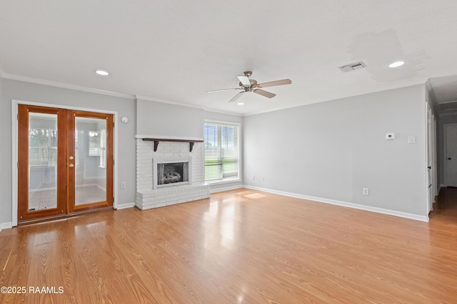 unfurnished living room with a ceiling fan, light wood-style flooring, crown molding, baseboards, and a fireplace
