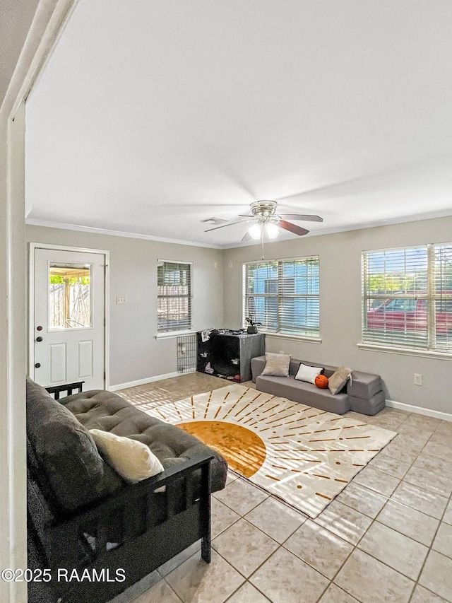 living room featuring healthy amount of natural light, light tile patterned flooring, baseboards, and ornamental molding