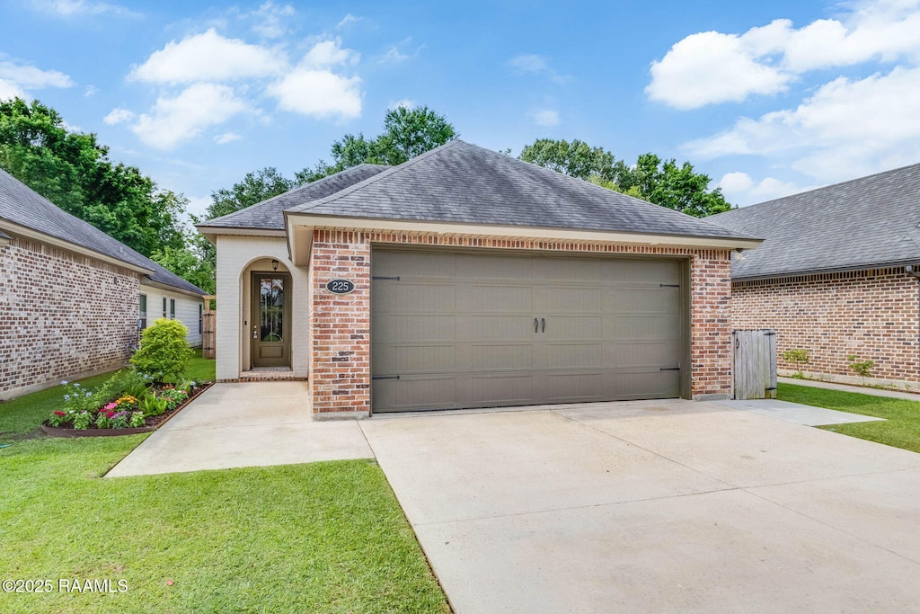 view of front of house featuring driveway, a shingled roof, brick siding, and a garage
