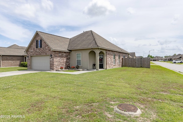 view of front facade featuring a front yard, roof with shingles, a garage, fence, and concrete driveway