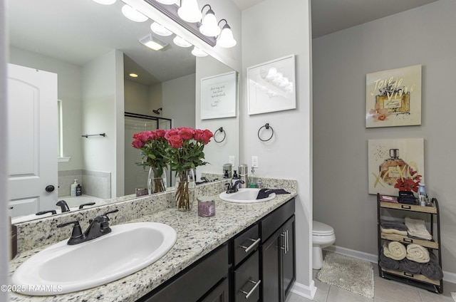 full bath with a sink, tile patterned floors, a shower stall, and double vanity