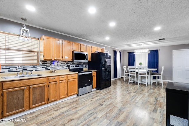kitchen with stainless steel appliances, a textured ceiling, a sink, and recessed lighting