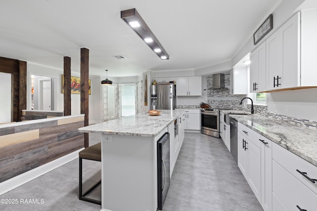334 Meche Rd, Carencro, LA 70520 - kitchen featuring stainless steel appliances, wall chimney range hood, a kitchen island, light stone countertops, and wine cooler