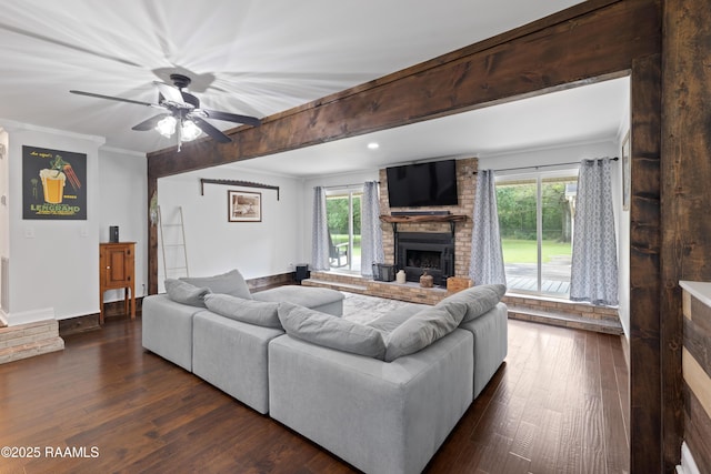 334 Meche Rd, Carencro, LA 70520 - living area featuring a brick fireplace, dark wood-style flooring, plenty of natural light, a ceiling fan, and ornamental molding