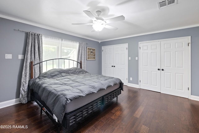 334 Meche Rd, Carencro, LA 70520 - bedroom with two closets, baseboards, wood finished floors, crown molding, and a ceiling fan
