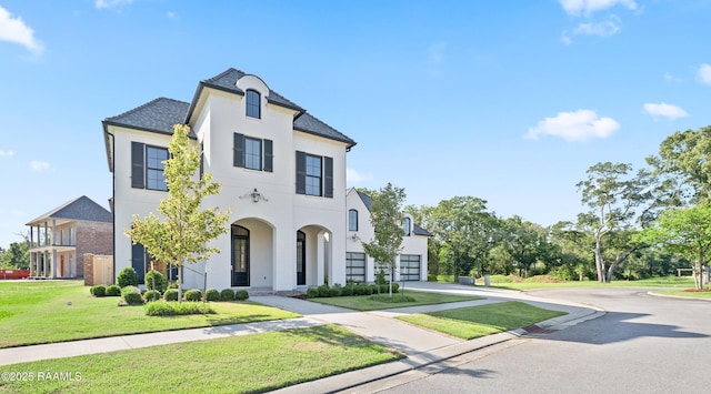 103 Arago Ct, Lafayette, LA 70508 - french country inspired facade with driveway, stucco siding, and a front lawn