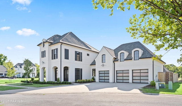 103 Arago Ct, Lafayette, LA 70508 - french country inspired facade featuring a garage, driveway, stucco siding, a high end roof, and fence