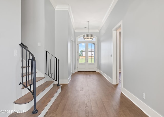 103 Arago Ct, Lafayette, LA 70508 - entrance foyer with crown molding, a chandelier, stairs, wood finished floors, and baseboards