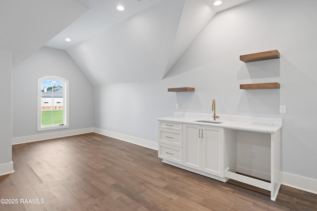 103 Arago Ct, Lafayette, LA 70508 - bar featuring vaulted ceiling, a sink, wood finished floors, baseboards, and recessed lighting