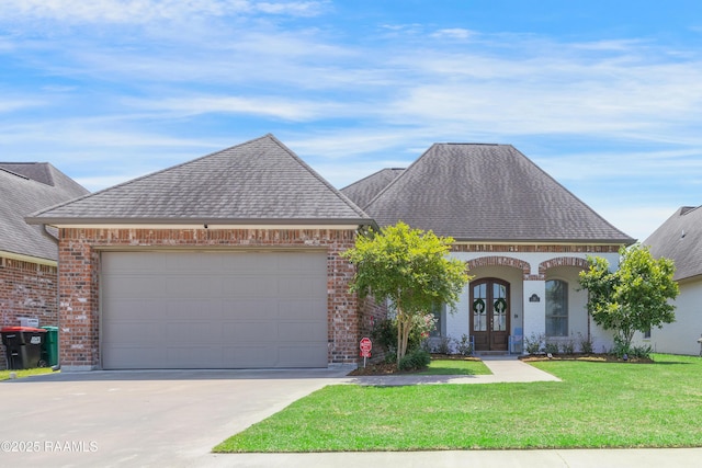 view of front of house featuring a shingled roof, a front lawn, brick siding, and concrete driveway